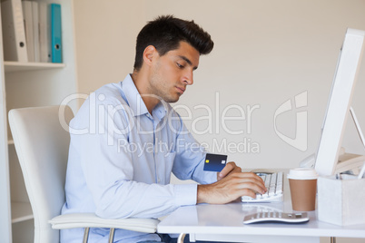 Casual businessman shopping online at his desk