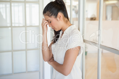 Casual upset businesswoman with head bowed