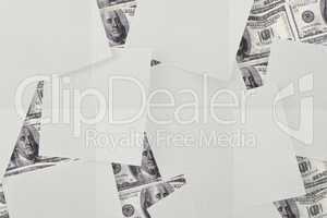 White paper strewn over dollar bills