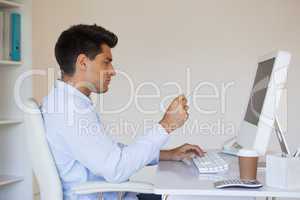 Casual businessman concentrating at his desk