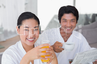 Couple in bathrobes spending the morning together