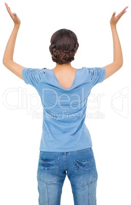 Brunette woman in jeans gesturing