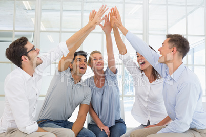 Group therapy in session sitting in a circle high fiving