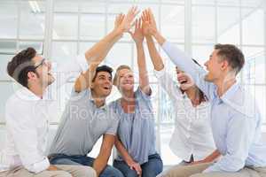 Group therapy in session sitting in a circle high fiving