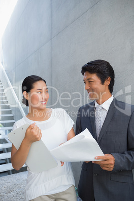 Estate agent showing lease to customer and smiling