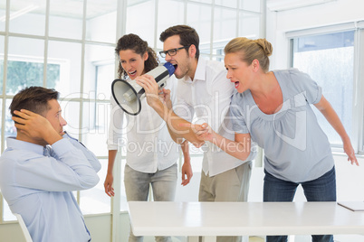 Casual business team shouting at a colleague