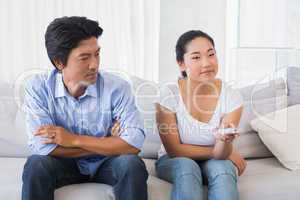 Man looking at girlfriend changing channel