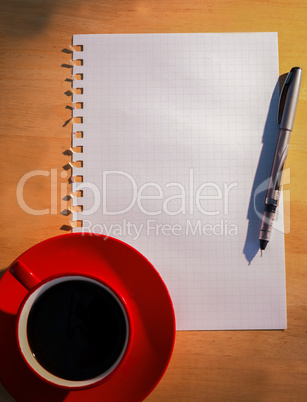 Overhead of graph paper coffee and pen