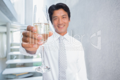 Happy man holding flute of champagne