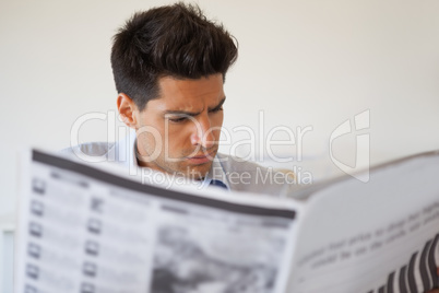 Casual businessman reading the newspaper
