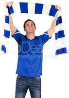 Football fan in blue holding scarf