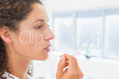 Casual businesswoman smoking an electronic cigarette