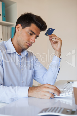 Casual businessman shopping online at his desk