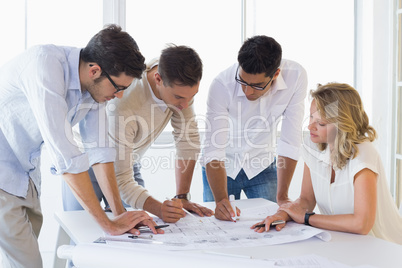 Casual architecture team working together at desk