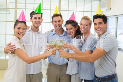 Casual smiling business team toasting with champagne