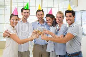 Casual smiling business team toasting with champagne