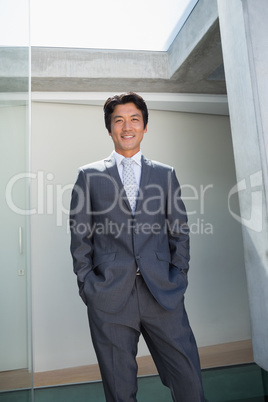 Confident estate agent standing at front door