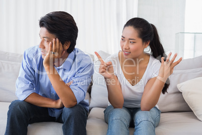 Couple having a dispute on the sofa