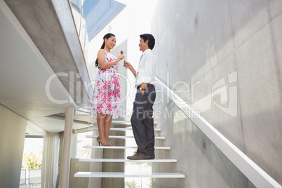 Man offering a red rose to girlfriend