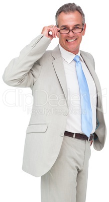 Thinking mature businessman touching glasses