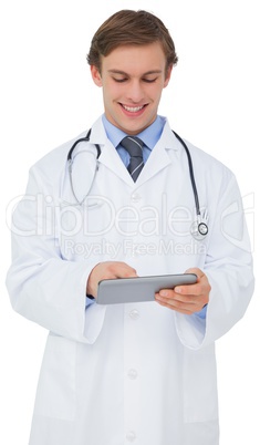 Young doctor in lab coat using tablet pc