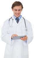 Young doctor in lab coat using tablet pc