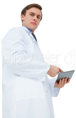 Young doctor in lab coat using tablet pc Young doctor in lab coat using tablet pc