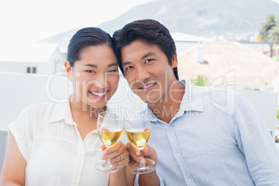 Happy couple having white wine