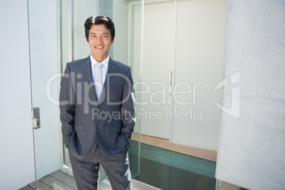 Confident estate agent standing at front door