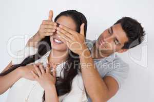 Man covering his pretty girlfriends eyes