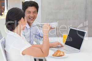 Smiling couple having breakfast together