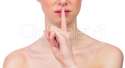 Beautiful woman making quiet gesture