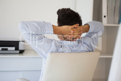 Casual businessman relaxing in swivel chair