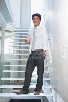 Serious man looking at camera holding champagne flute