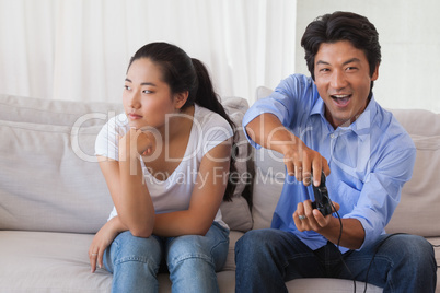 Man ignoring his girlfriend playing video games