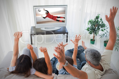 Family cheering and watching the world cup at home