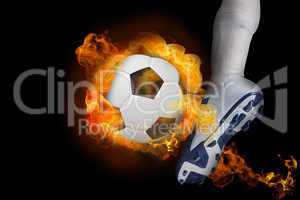 Football player kicking flaming ball