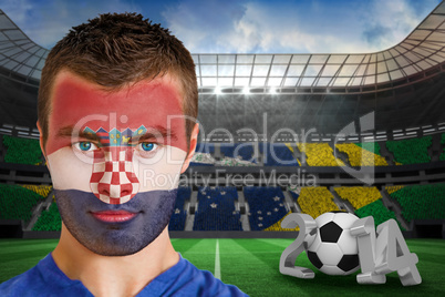 Serious young croatia fan with face paint