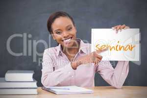 Happy teacher holding page showing seminar