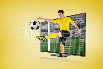 Football player kicking ball through tv