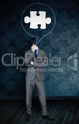 Composite image of headless businessman with jigsaw in speech bu