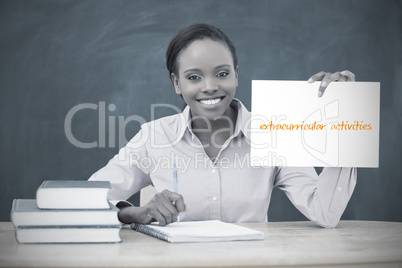 Happy teacher holding page showing extracurricular activities
