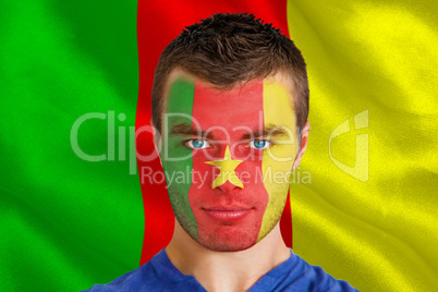 Serious young cameroon fan with facepaint