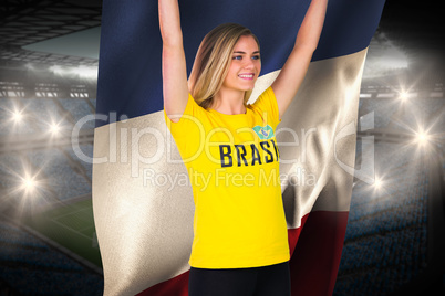 Excited football fan in brasil tshirt holding france flag