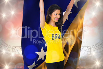 Excited football fan in brasil tshirt holding bosnia flag