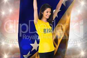 Excited football fan in brasil tshirt holding bosnia flag