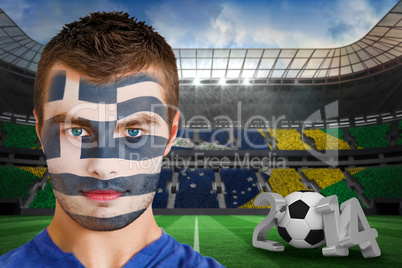 Serious young greece fan with face paint