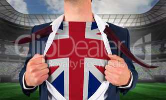 Businessman opening shirt to reveal union jack flag