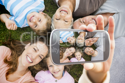 Composite image of hand holding smartphone showing