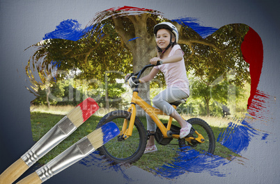 Composite image of little girl on a bike